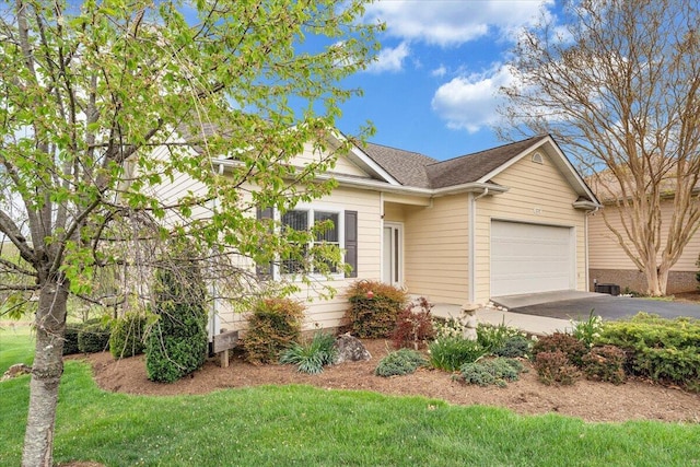 ranch-style home with a garage and aphalt driveway