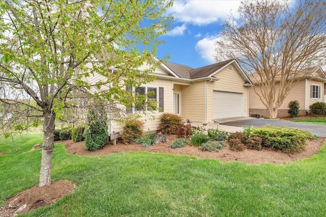 single story home featuring an attached garage, a front lawn, and aphalt driveway