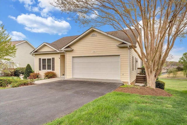 view of front of home featuring a garage, aphalt driveway, and a front lawn