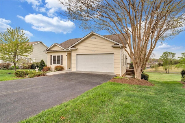 view of front of home with a garage, aphalt driveway, and a front yard