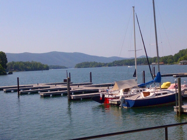 view of dock featuring a water and mountain view