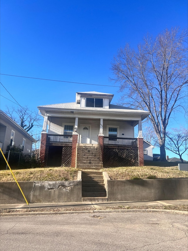 view of front facade with stairs and covered porch