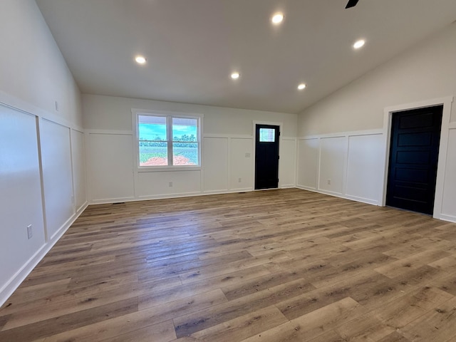 1484 White House Rd, Moneta, VA 24121 - unfurnished room featuring a decorative wall, wood finished floors, recessed lighting, vaulted ceiling, and wainscoting