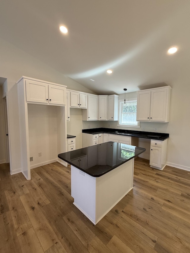 1484 White House Rd, Moneta, VA 24121 - kitchen featuring white cabinets, wood finished floors, lofted ceiling, dark countertops, and recessed lighting