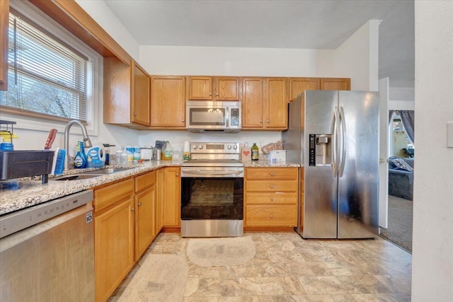 728 Jamison Ave SE, Roanoke, VA 24013 - kitchen with light stone counters, appliances with stainless steel finishes, and a sink