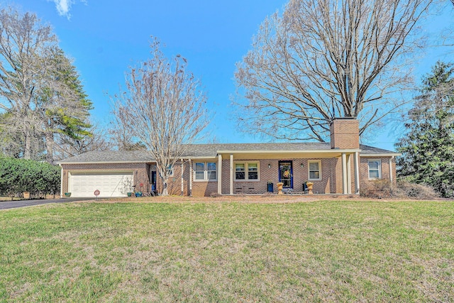 ranch-style house with brick siding, a front yard, driveway, and a garage