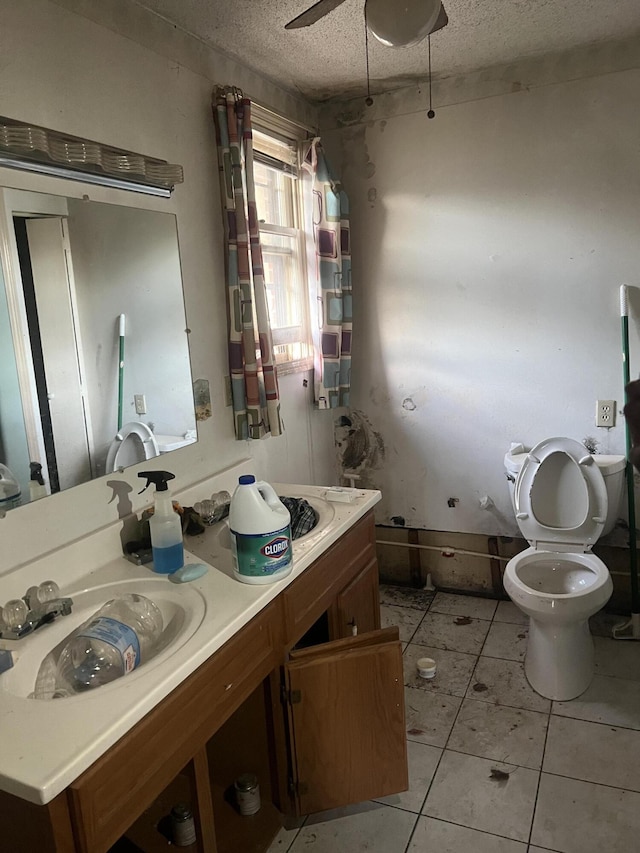 451 Grand Lake Dr, Ridgeway, VA 24148 - bathroom with tile patterned floors, toilet, a ceiling fan, a textured ceiling, and vanity