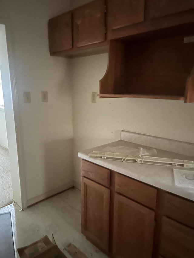 451 Grand Lake Dr, Ridgeway, VA 24148 - kitchen with light countertops, brown cabinetry, and baseboards