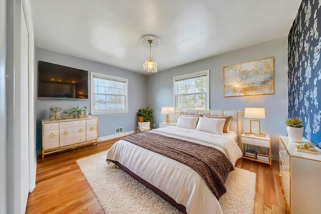 1401 Grove Dr, Pulaski, VA 24301 - bedroom with light wood-style flooring, baseboards, and multiple windows