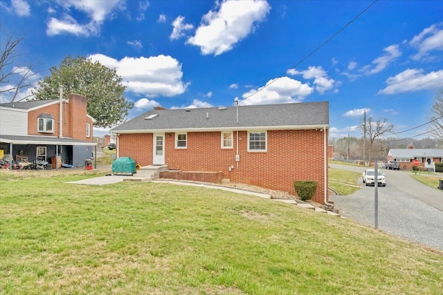 1401 Grove Dr, Pulaski, VA 24301 - rear view of house with a lawn and brick siding