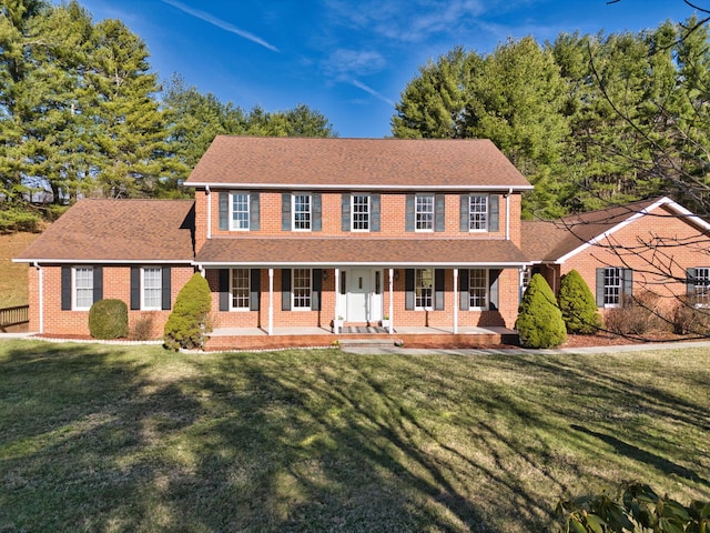 195 Showalter Rd NW, Willis, VA 24380 - colonial house featuring brick siding, a porch, a front lawn, and a shingled roof