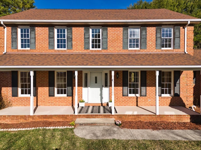 195 Showalter Rd NW, Willis, VA 24380 - view of front of home featuring covered porch, a shingled roof, and brick siding