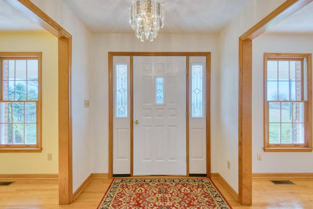 195 Showalter Rd NW, Willis, VA 24380 - foyer entrance with light wood-type flooring, healthy amount of natural light, and a chandelier