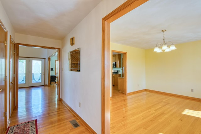 195 Showalter Rd NW, Willis, VA 24380 - corridor with light wood-type flooring and a chandelier