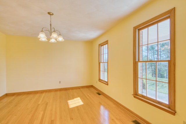 195 Showalter Rd NW, Willis, VA 24380 - empty room with light wood-type flooring and a chandelier