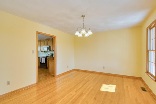 195 Showalter Rd NW, Willis, VA 24380 - empty room with a chandelier, light wood finished floors, and plenty of natural light