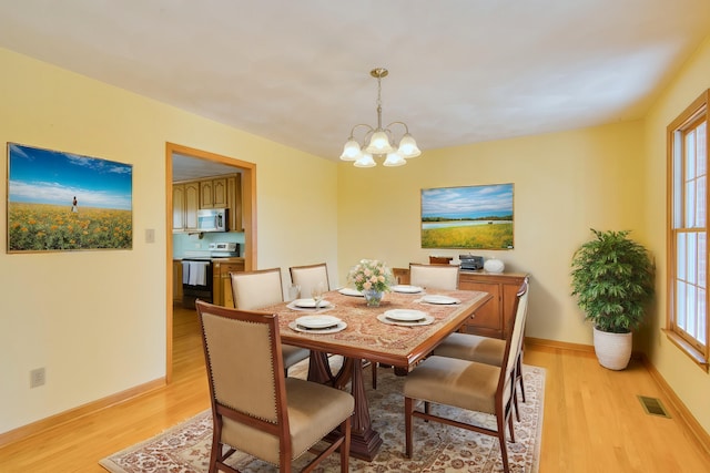 195 Showalter Rd NW, Willis, VA 24380 - dining space with light wood-style flooring, a chandelier, and healthy amount of natural light