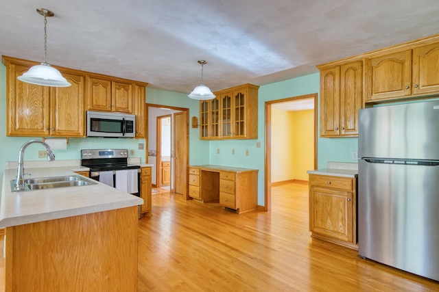195 Showalter Rd NW, Willis, VA 24380 - kitchen with appliances with stainless steel finishes, light wood-style floors, glass insert cabinets, and light countertops