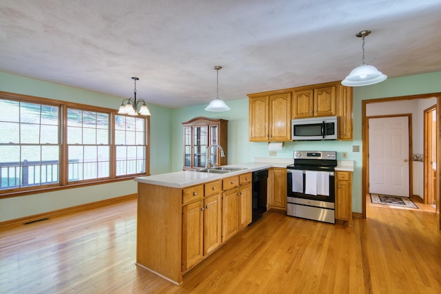 195 Showalter Rd NW, Willis, VA 24380 - kitchen with appliances with stainless steel finishes, a peninsula, light countertops, and light wood-type flooring
