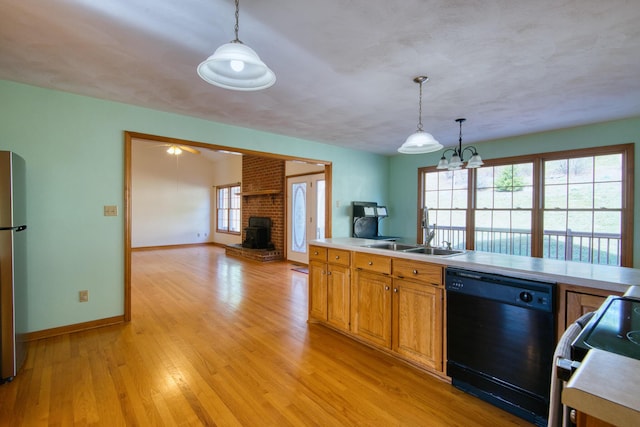 195 Showalter Rd NW, Willis, VA 24380 - kitchen with black dishwasher, range, light countertops, light wood-style flooring, and hanging light fixtures