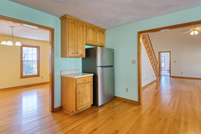 195 Showalter Rd NW, Willis, VA 24380 - kitchen featuring freestanding refrigerator, light wood-style flooring, light countertops, a ceiling fan, and a chandelier