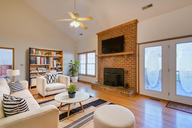 195 Showalter Rd NW, Willis, VA 24380 - living room with wood finished floors, high vaulted ceiling, a ceiling fan, and a wood stove