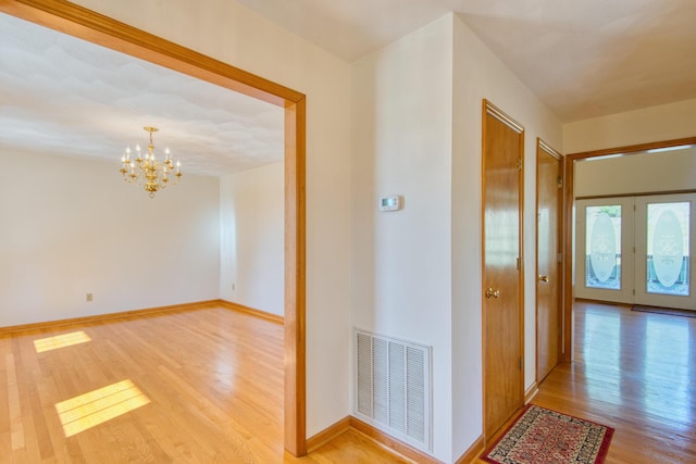 195 Showalter Rd NW, Willis, VA 24380 - hallway featuring light wood-style floors and a chandelier