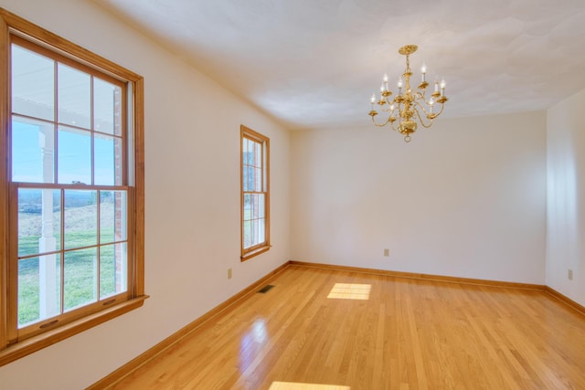 195 Showalter Rd NW, Willis, VA 24380 - empty room featuring healthy amount of natural light, light wood-type flooring, and a chandelier