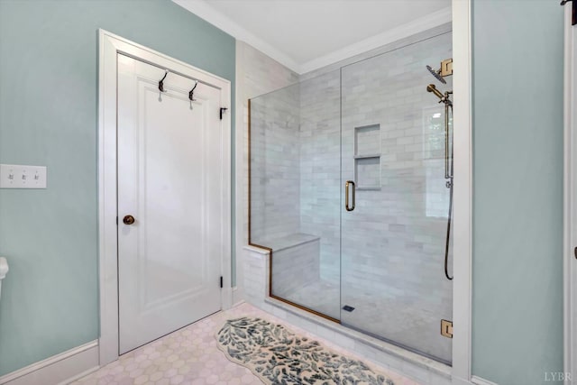 full bathroom featuring a stall shower and crown molding