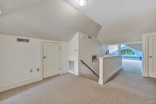 bonus room with visible vents, lofted ceiling, and carpet flooring