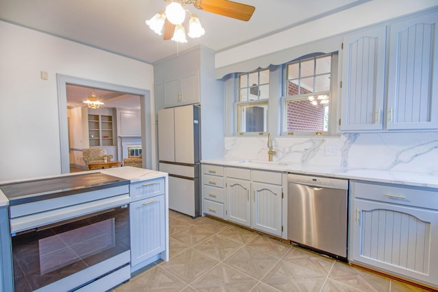 kitchen with a sink, a ceiling fan, electric range oven, freestanding refrigerator, and dishwasher