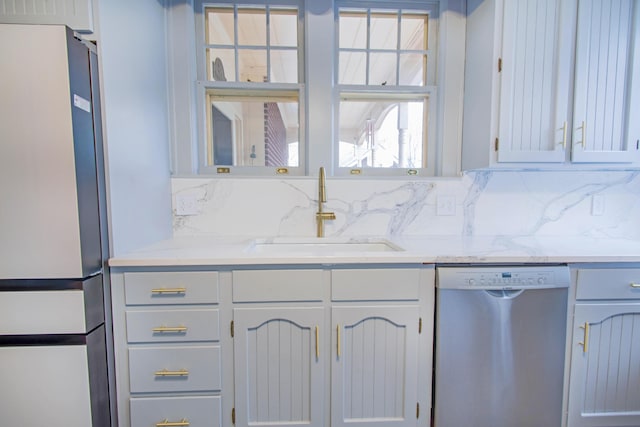 kitchen featuring backsplash, a sink, and appliances with stainless steel finishes