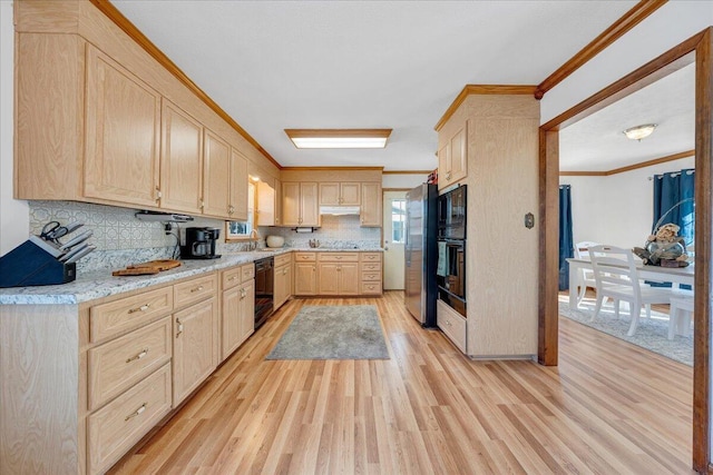kitchen with light countertops, tasteful backsplash, ornamental molding, light brown cabinetry, and black appliances