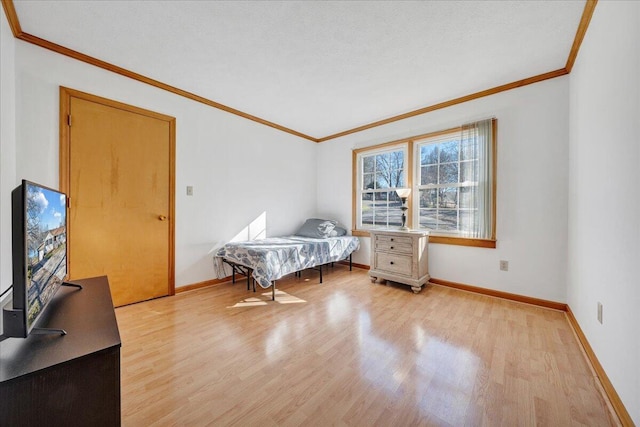 bedroom with baseboards, ornamental molding, and light wood-type flooring