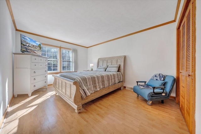 bedroom featuring light wood finished floors and ornamental molding