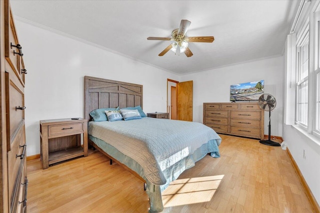 bedroom with baseboards, light wood-style flooring, ceiling fan, and ornamental molding
