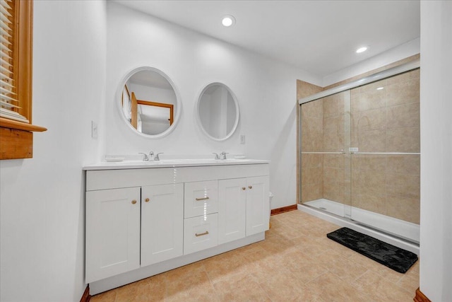 bathroom featuring double vanity, a sink, recessed lighting, and a shower stall