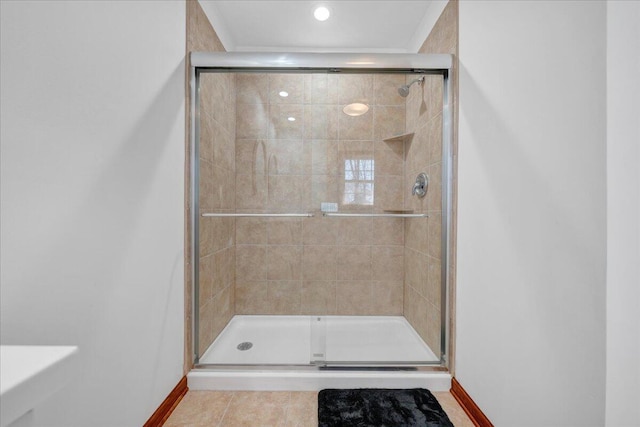 bathroom with a shower stall and tile patterned flooring