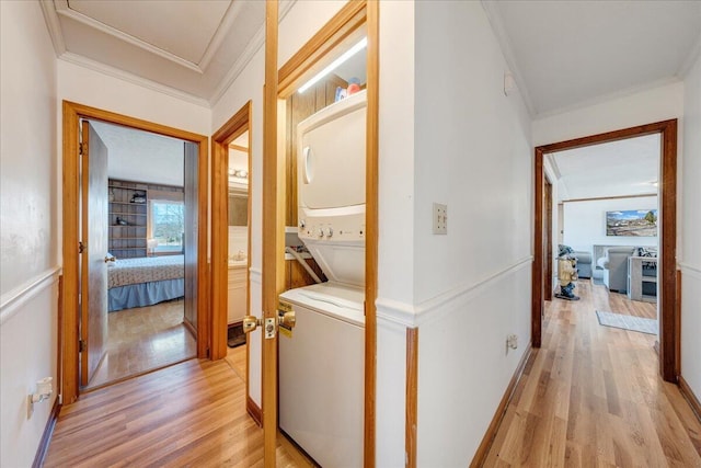 hallway with crown molding and light wood-type flooring