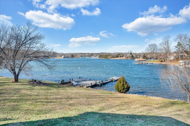 exterior space featuring a lawn and a water view