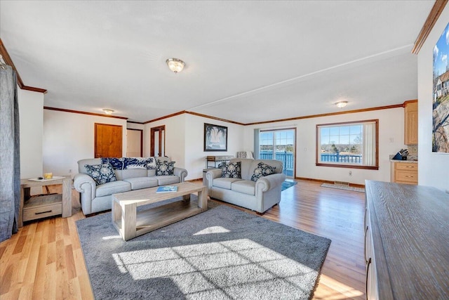 living room with light wood-style flooring and ornamental molding
