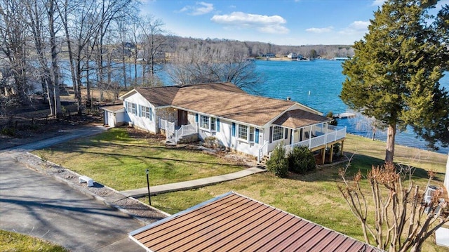 view of front of property featuring a front lawn, covered porch, and a water view