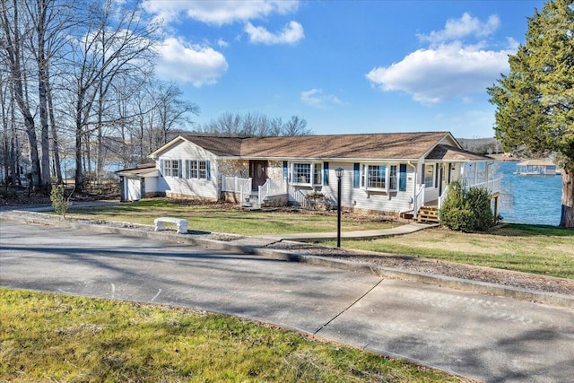 ranch-style house featuring a front lawn and a garage