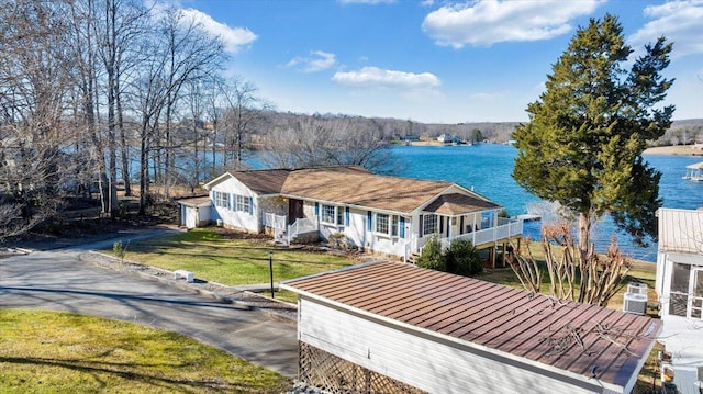 view of front of home featuring a water view and a front lawn