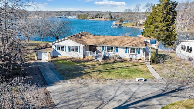 single story home with a water view, a garage, concrete driveway, and a front yard
