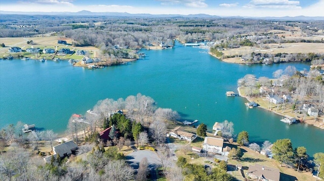 aerial view with a water view and a forest view
