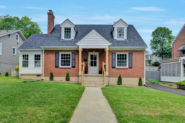 2619 Carolina Ave SW, Roanoke, VA 24014 - new england style home with brick siding, a front yard, and a chimney