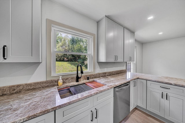 2619 Carolina Ave SW, Roanoke, VA 24014 - kitchen with dishwasher, a sink, light stone counters, light wood-type flooring, and recessed lighting