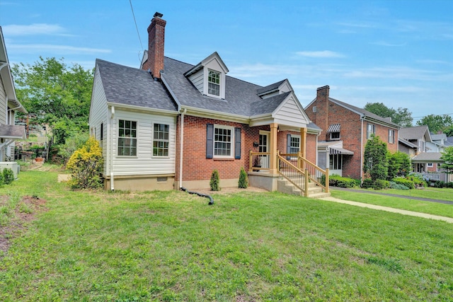 2619 Carolina Ave SW, Roanoke, VA 24014 - cape cod-style house with a front yard, roof with shingles, a chimney, and brick siding