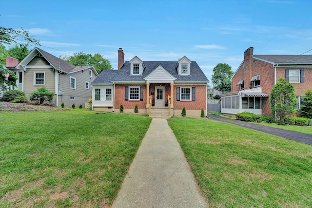 2619 Carolina Ave SW, Roanoke, VA 24014 - new england style home featuring brick siding, a front yard, and a chimney